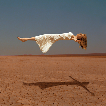 floating woman above desert